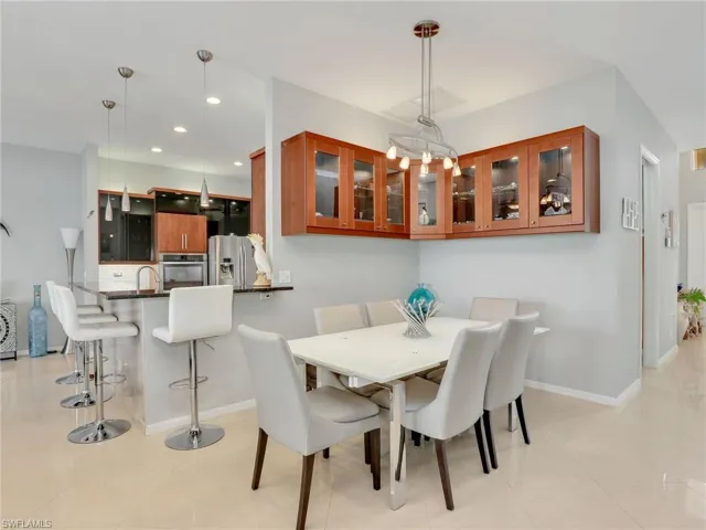 Dining room featuring light tile patterned floors and sink