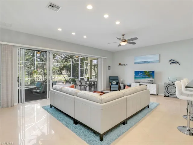 Tiled living room featuring ceiling fan