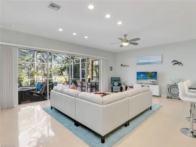 Tiled living room featuring ceiling fan