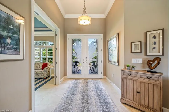 Tiled entryway with double doors
