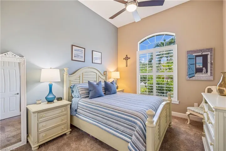 Large Guest Bedroom with vaulted ceiling, and carpet