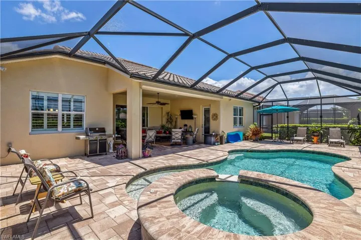 View of large solar heated, salt water pool and a in-ground hot tub