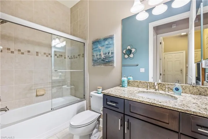 Guest bathroom featuring Guest bath / shower combo with glass  doors