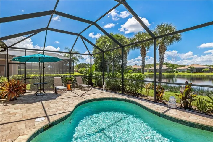 View of swimming pool with a lake view