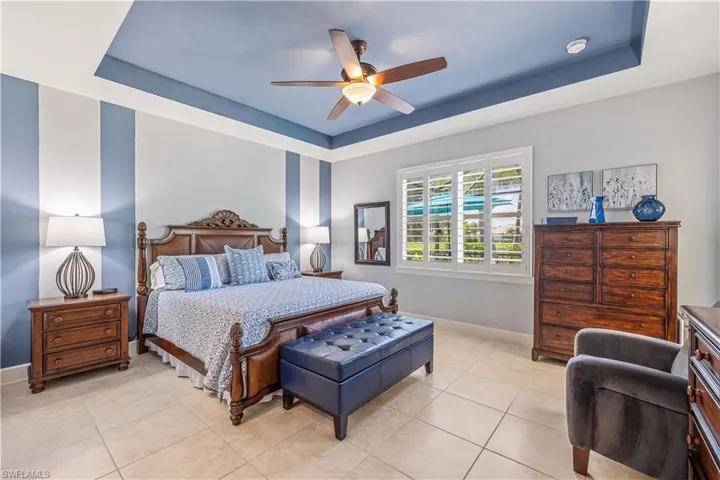 Master Bedroom featuring tile floors and tray ceiling
