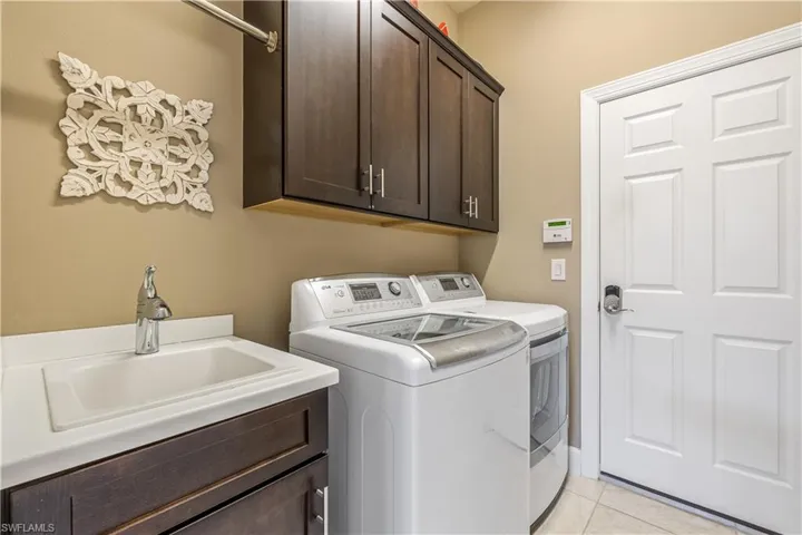 Built-in laundry sink with custom cabinets