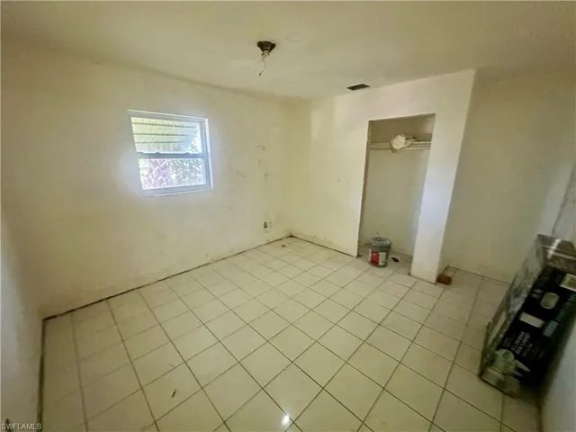 Empty room featuring tile patterned floors