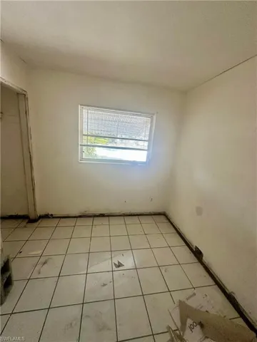 Empty room featuring light tile patterned flooring
