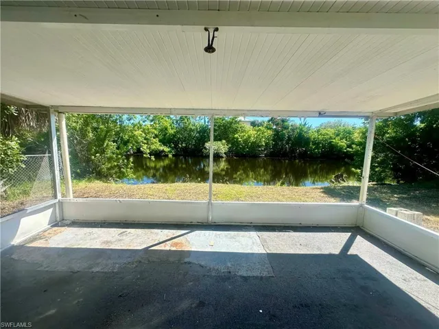 Unfurnished sunroom with a water view