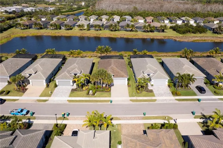 Aerial perspective of suburban area featuring a large body of water