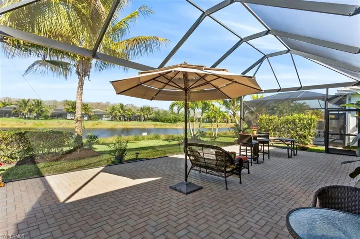 View of patio / terrace with glass enclosure, a sunroom, an outdoor living space, and a water view