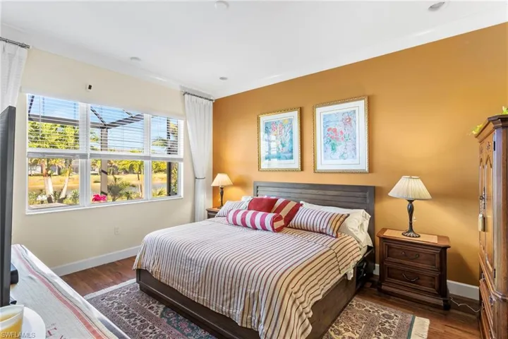Bedroom featuring dark wood finished floors and ornamental molding