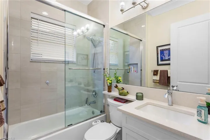 Bathroom with vanity and shower / bath combination with glass door