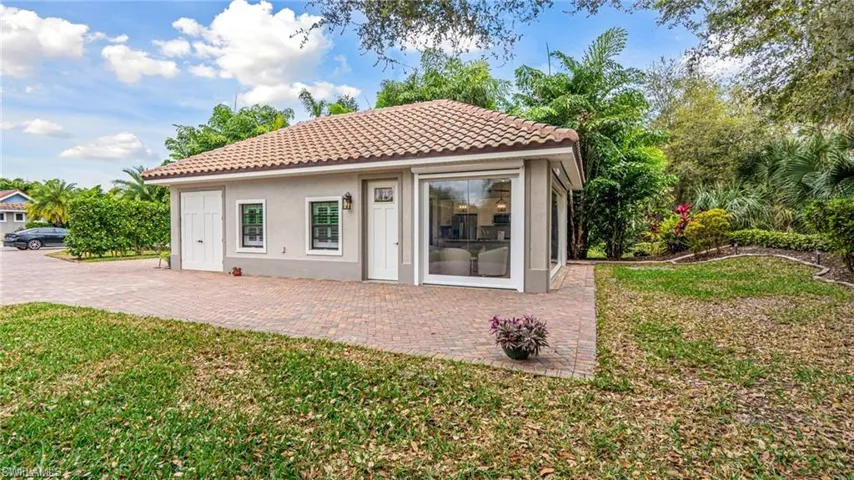 Cabana, golf cart garage, front door & seating area