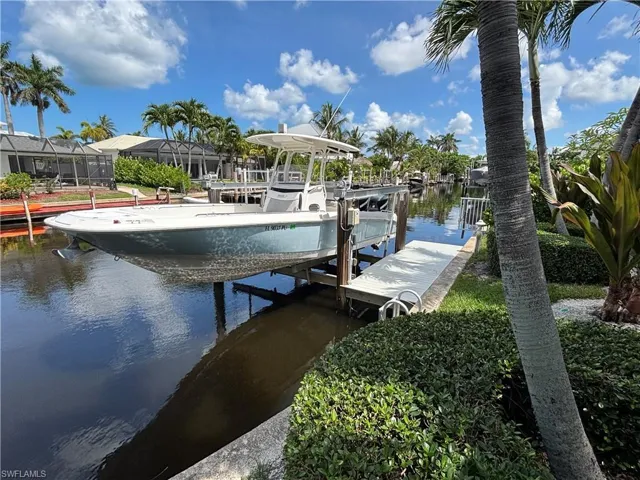 Dock area with a water view and boat lift