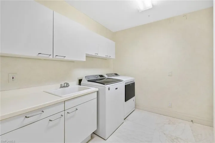 Large utility room with plenty of cabinets for storage!