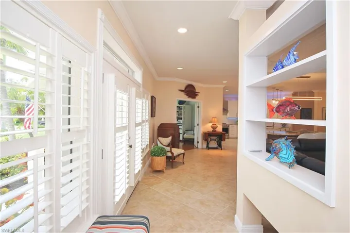Custom plantation shutters and transom window enhance the front of the property