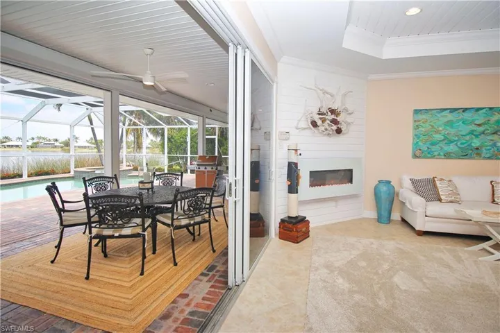 Large sliding doors open to the oversized brick-pavered lanai, perfect for indoor-outdoor living