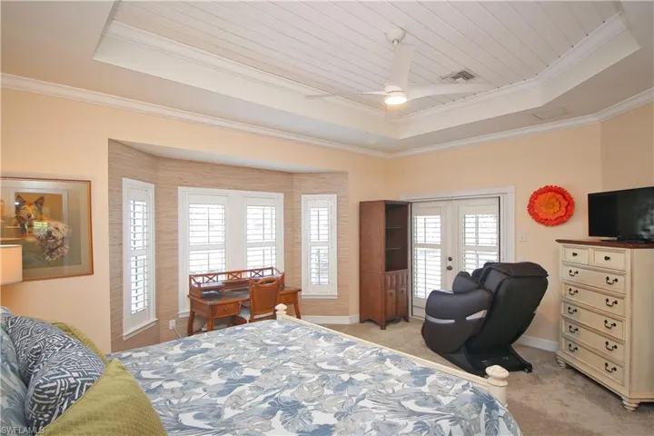 Primary suite with French doors to lanai and pool