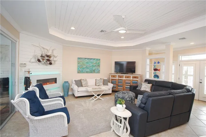 Spacious living area with electric fireplace and shiplap accents