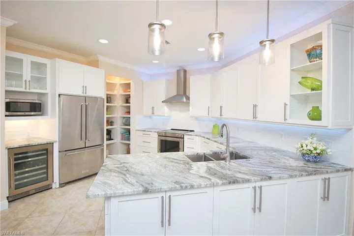 New kitchen featuring modern cabinetry with ample storage space and wine cooler