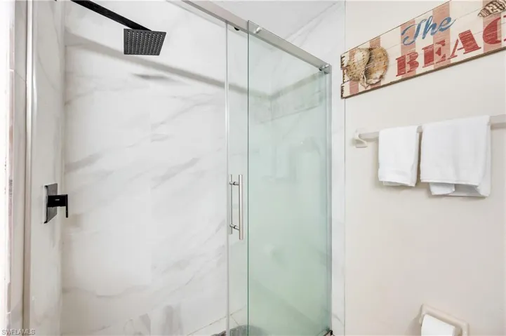 Full bath featuring a marble finish shower