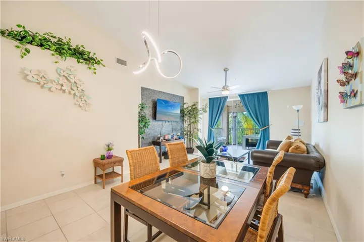 Dining room with a ceiling fan and light tile patterned floors