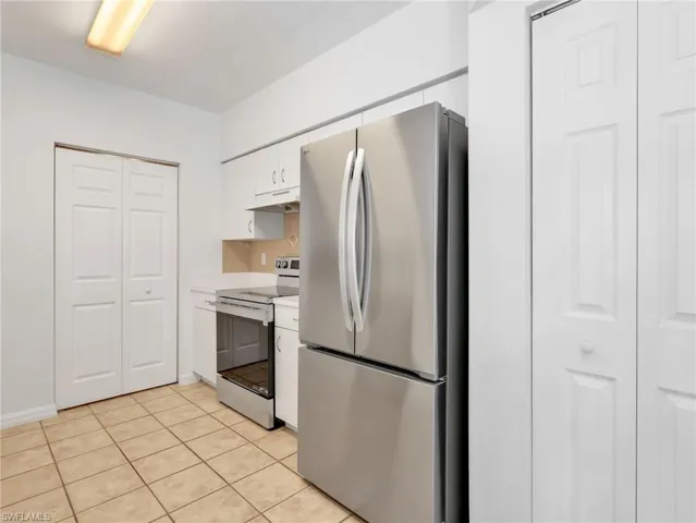 Kitchen with Tile Flooring, White Cabinetry, Stainless Steel Appliances Including new LG French Door Refrigerator & Range, Tile Backsplash & Pantry