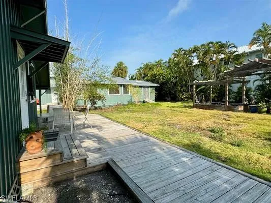 Wooden terrace featuring a lawn