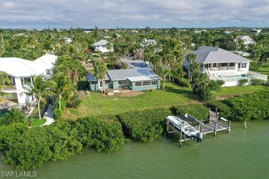 Aerial view of property and surrounding area with a large body of water