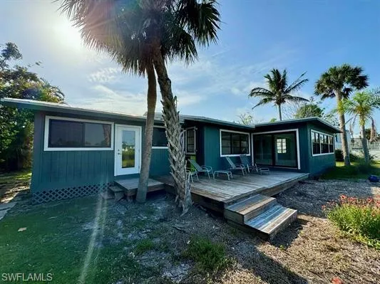 Rear view of property featuring a wooden deck