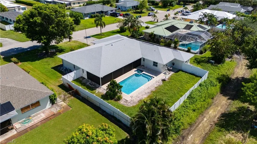 White exterior with a light-colored roof and a private swimming pool