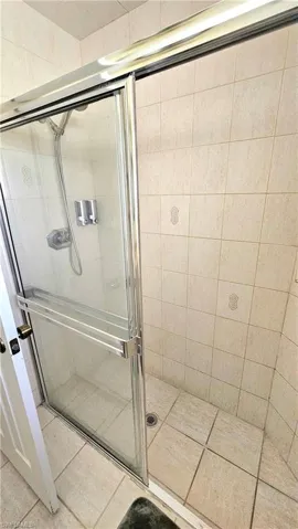 Bathroom with tile patterned flooring and walk in shower
