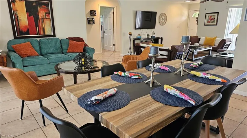 Tiled dining area featuring ceiling fan