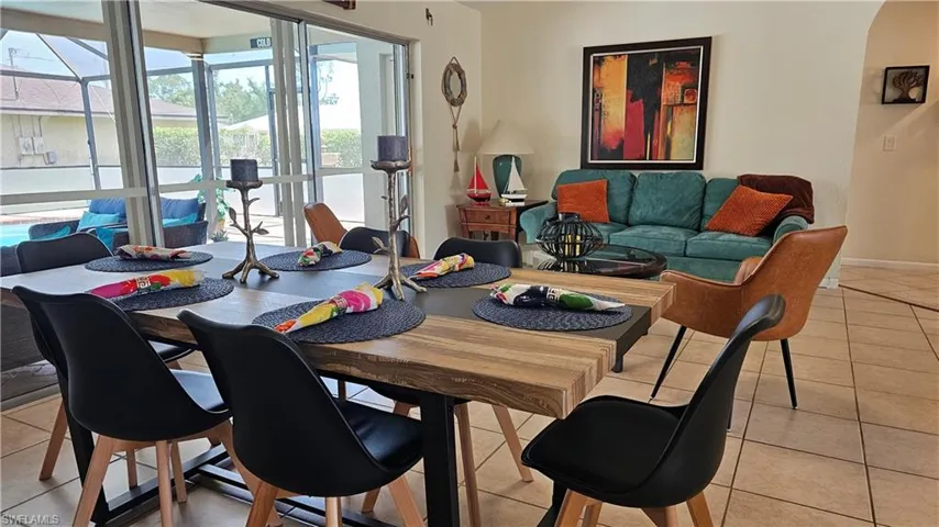 Dining space with light tile patterned floors