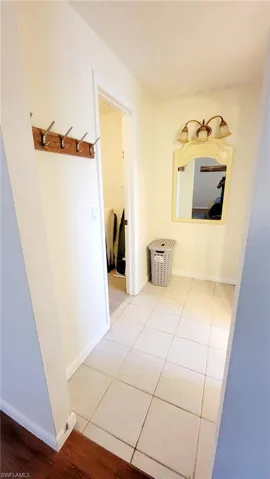 Corridor featuring light tile patterned floors