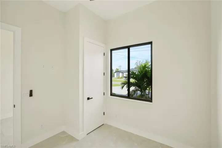 Unfurnished room with baseboards