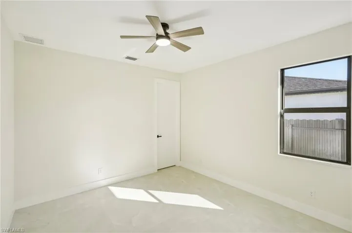 Empty room with baseboards and a ceiling fan