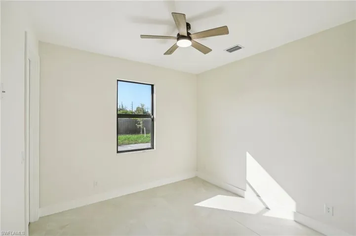 Unfurnished room with a ceiling fan and light tile patterned floors