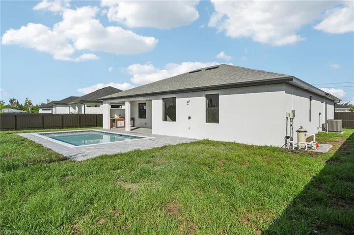 Back of house featuring a patio, a fenced backyard, a shingled roof, and stucco siding