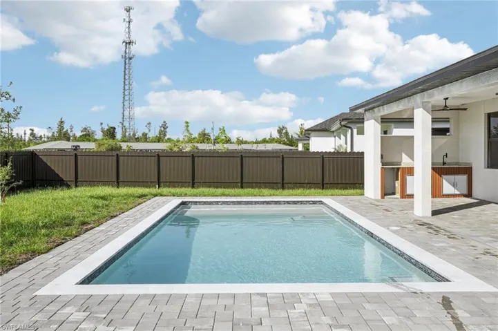 View of pool featuring a fenced backyard, a patio area, and a ceiling fan