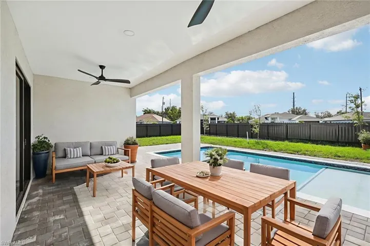 Fenced backyard with a patio area, ceiling fan, outdoor lounge area, and outdoor dining space