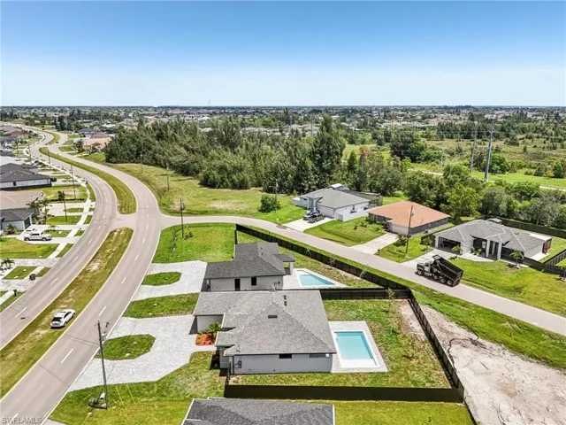 Aerial perspective of suburban area featuring a pool