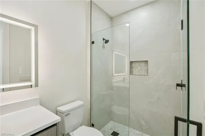 Full bath with a shower stall and vanity