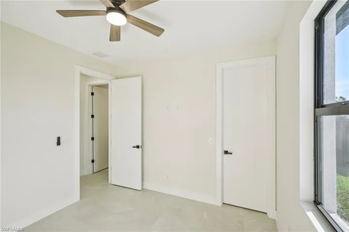 Unfurnished bedroom with baseboards and a ceiling fan