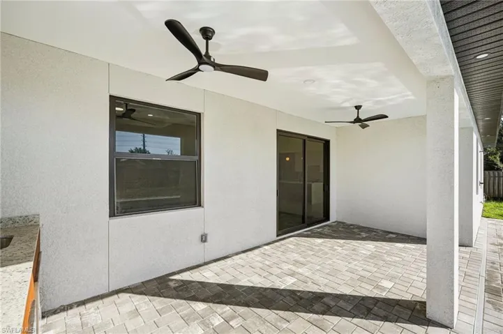 View of patio featuring ceiling fan