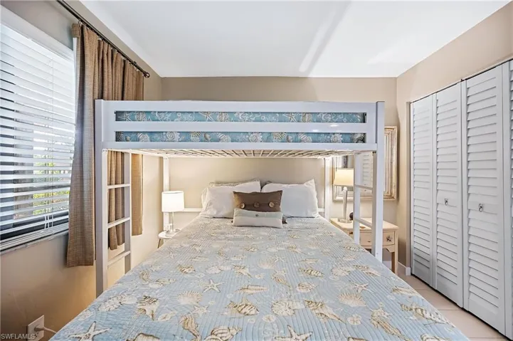 2nd bedroom with Queen and twin bunkspatterned floors