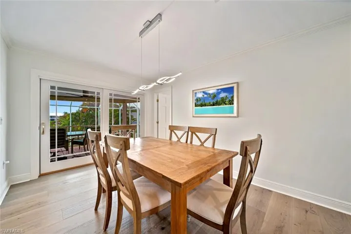 Dining room featuring light hardwood / wood-style floors and crown molding