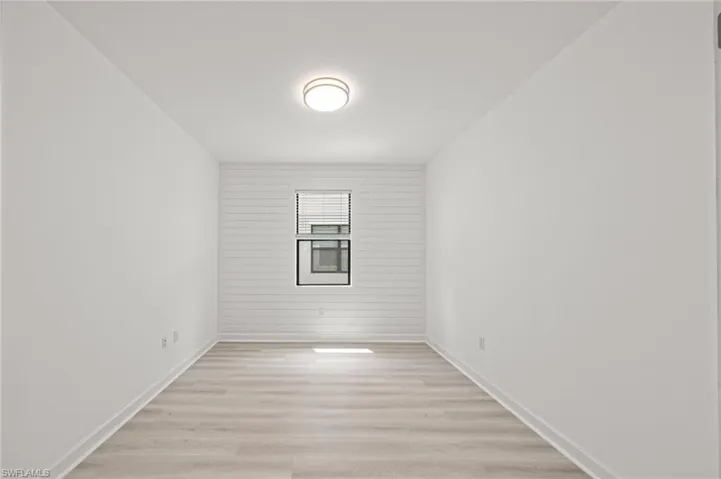 Unfurnished room with light wood-style flooring