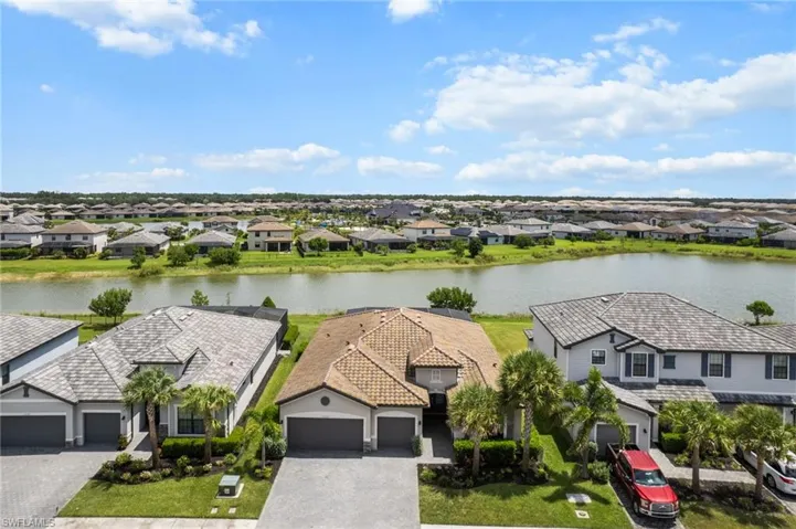 Aerial perspective of suburban area featuring a nearby body of water